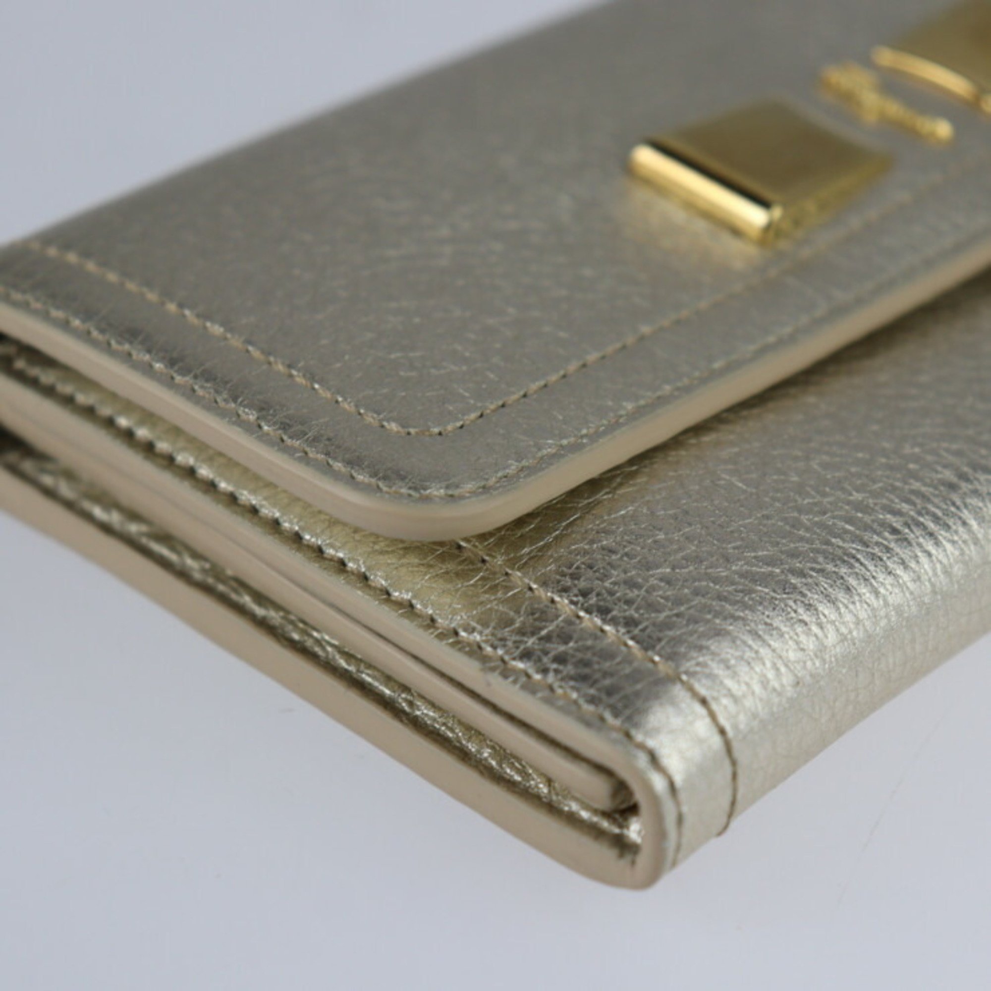 Salvatore Ferragamo bi-fold wallet 22 C954 leather champagne gold long ribbon